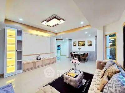 Spacious modern living room with elegant decor and open dining area, perfect for family gatherings.