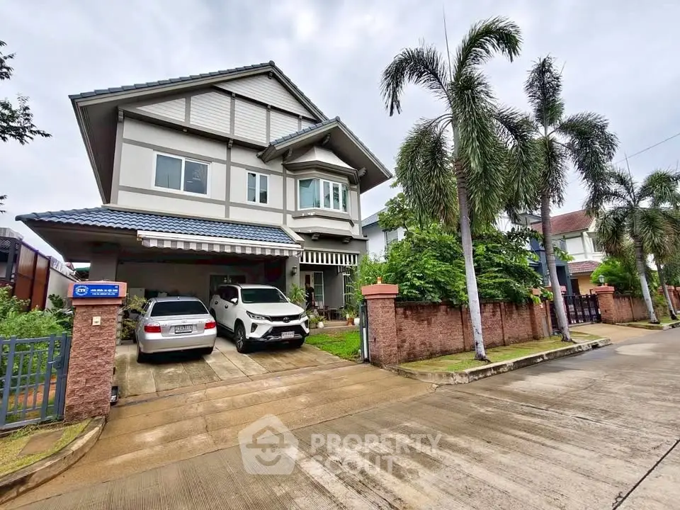 Charming two-story house with spacious driveway and lush garden in a serene neighborhood.