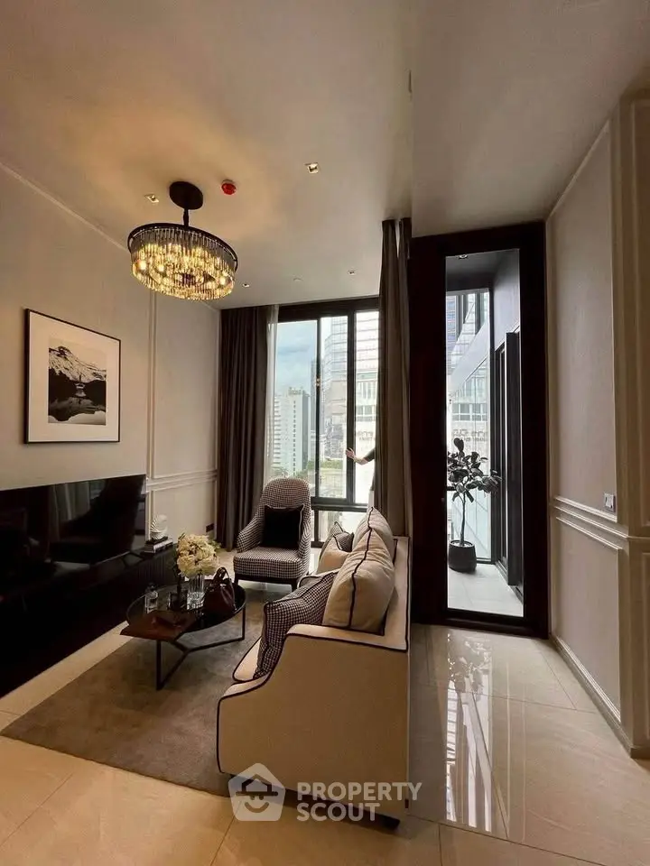 Luxurious living room with elegant decor and city view, featuring plush seating and a chic chandelier.