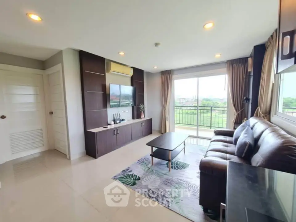 Spacious living room with modern decor and large window offering scenic views.