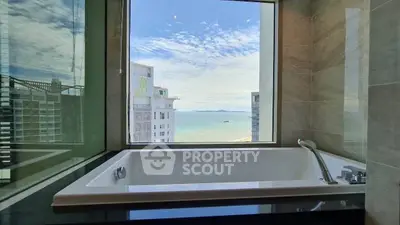 Luxurious bathroom with ocean view from a modern bathtub, perfect for relaxation.