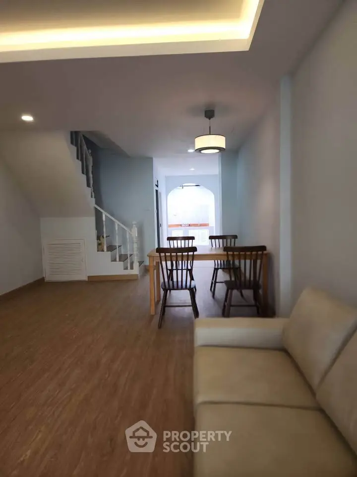 Spacious living area with modern decor and wooden flooring in a stylish home.