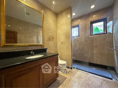 Luxurious bathroom with elegant marble finishes and spacious walk-in shower.