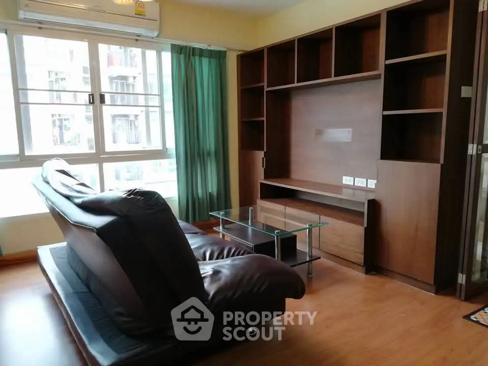 Spacious living room with modern sofa and large windows for natural light.