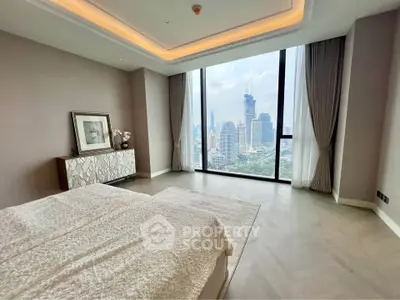 Luxurious bedroom with floor-to-ceiling windows offering stunning city skyline views.
