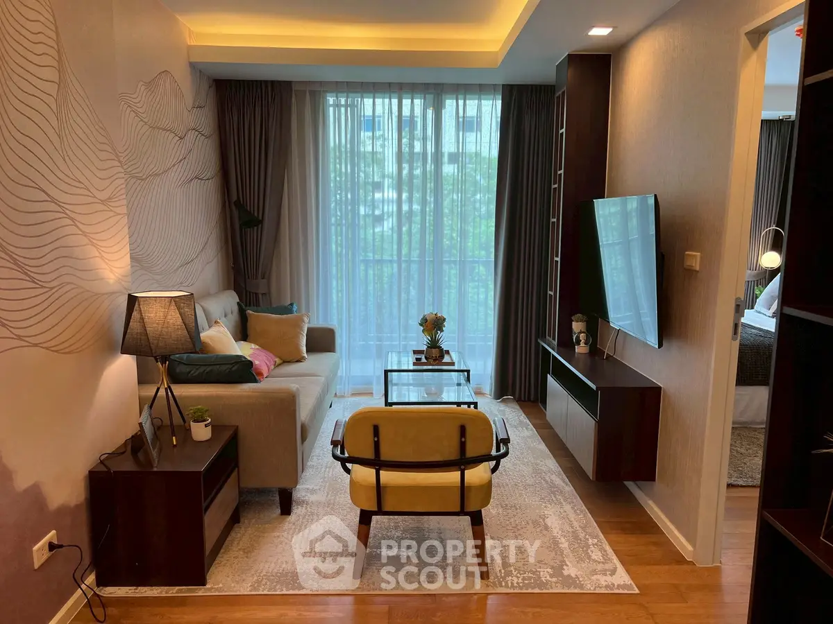 Stylish living room with modern decor and large window offering natural light.