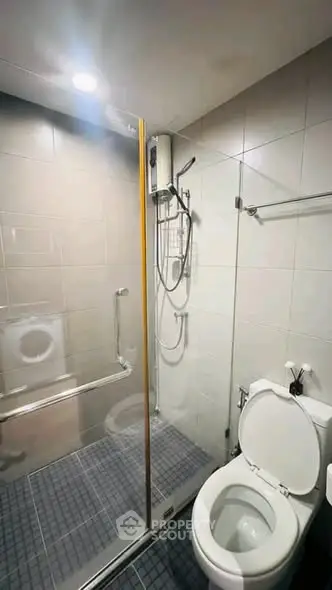 Modern bathroom with glass shower enclosure and sleek fixtures
