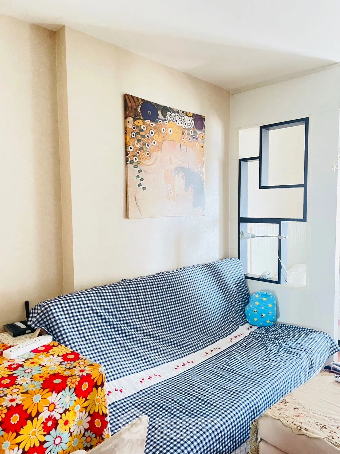 Cozy living room with floral decor and modern art, perfect for relaxation.