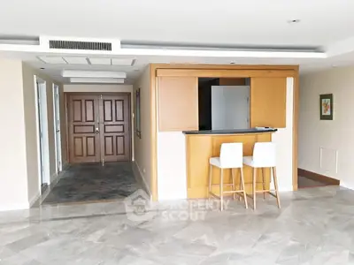 Spacious open living area with modern bar counter and elegant flooring