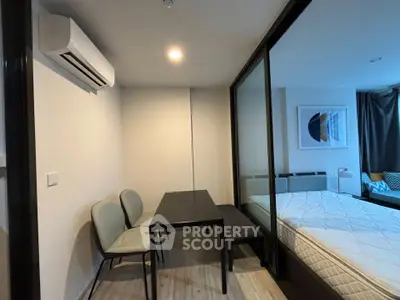 Modern bedroom with glass partition and air conditioning in stylish apartment