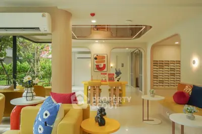 Modern living room with vibrant decor and garden view, featuring stylish furniture and open layout.