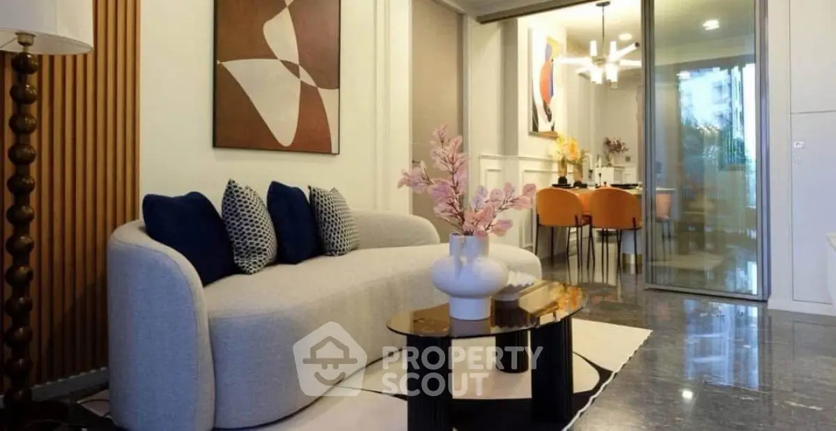 Modern living room with stylish decor and open layout leading to dining area.