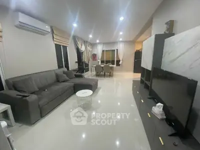 Spacious modern living room with sleek furniture and ambient lighting
