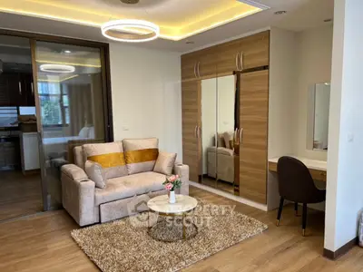 Modern living room with stylish sofa, mirrored wardrobe, and cozy decor