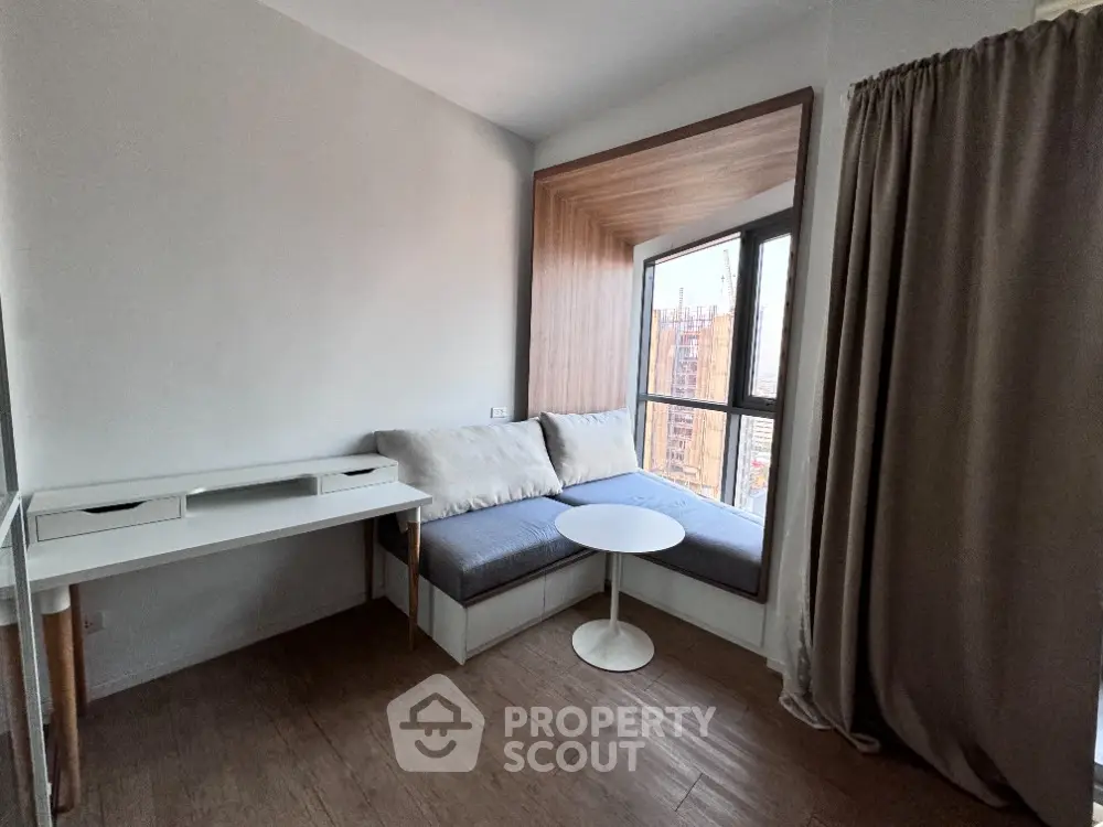 Cozy study nook with window seating and modern desk in urban apartment