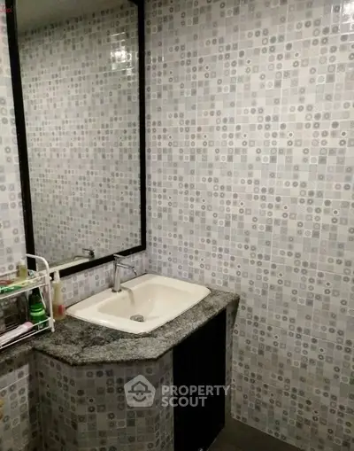 Modern bathroom with stylish tile design and sleek sink area