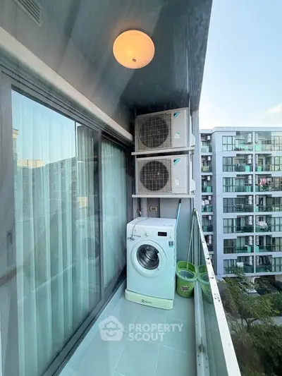 Modern balcony with washing machine and air conditioning units in urban apartment