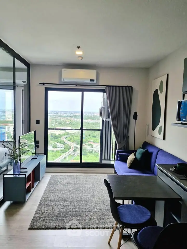 Modern living room with large window offering stunning city view, stylish furniture, and contemporary decor.