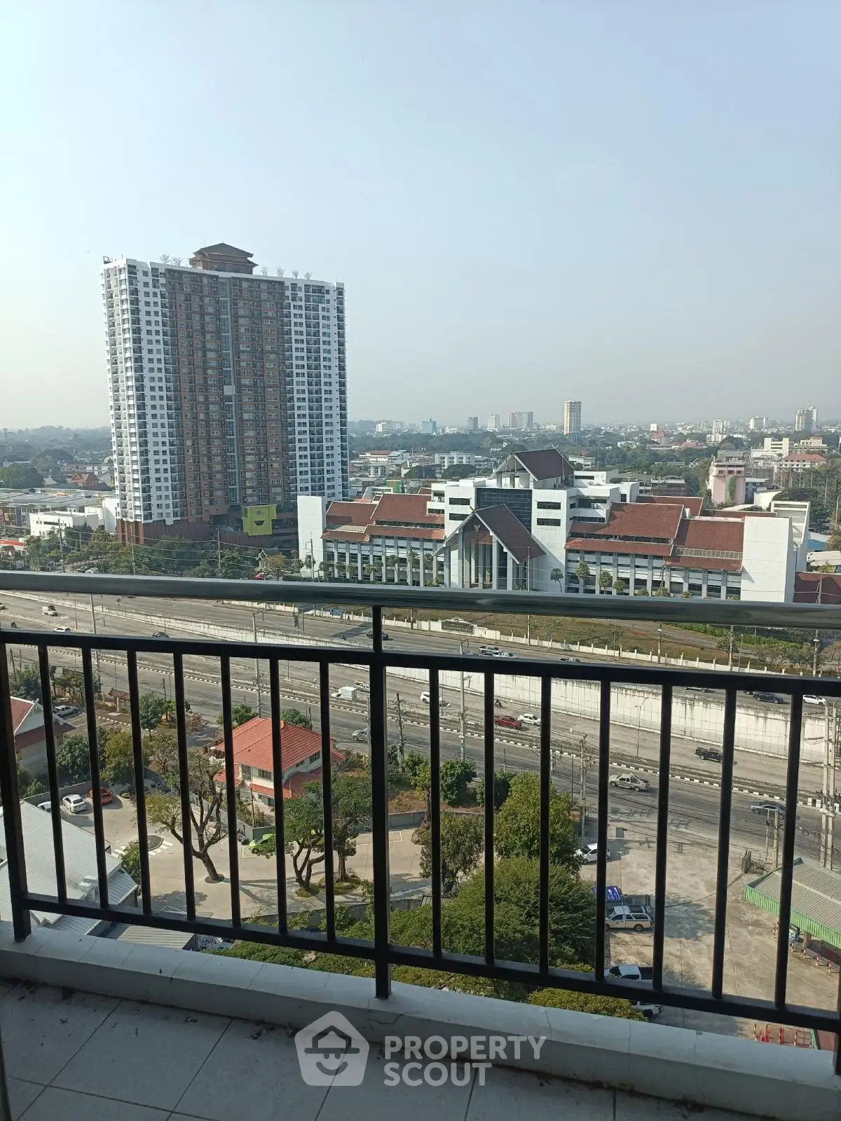Stunning cityscape view from high-rise balcony overlooking urban skyline and modern architecture.