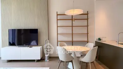 Modern living room with stylish dining area and sleek TV setup