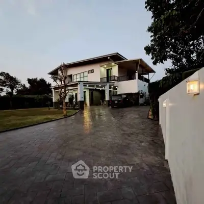 Luxurious modern two-story home with spacious driveway and lush garden