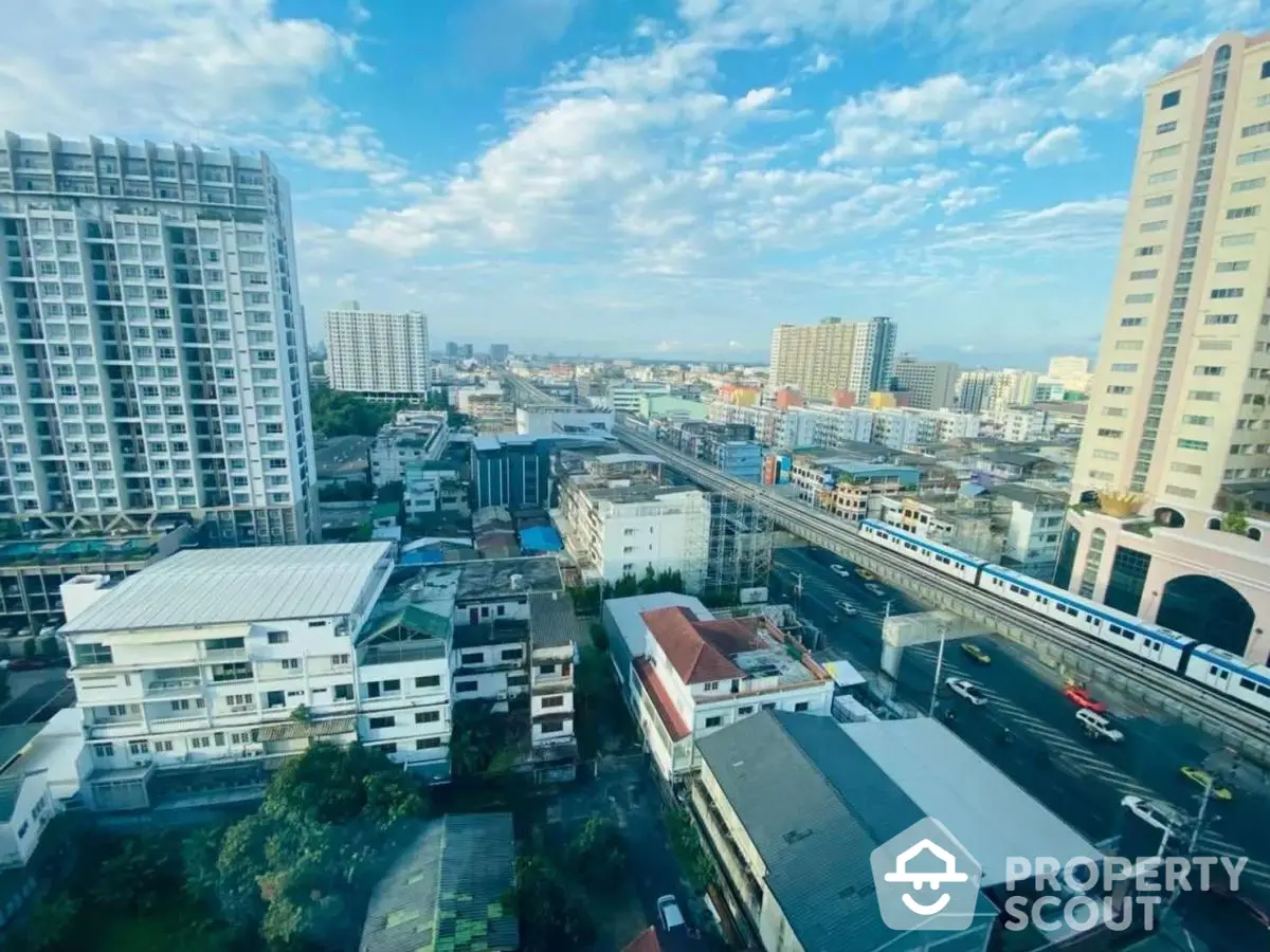 Stunning cityscape view from high-rise apartment with clear blue sky and urban skyline.