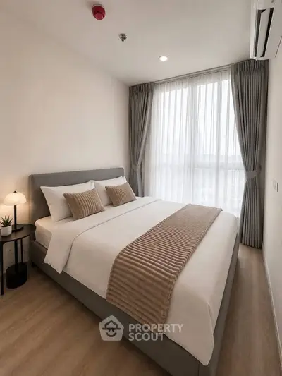 Modern bedroom with elegant decor and large window for natural light