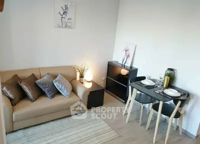 Cozy living room with modern decor and dining area, perfect for urban living.