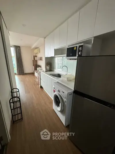 Modern kitchen with sleek appliances and open layout in a stylish apartment.