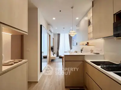 Modern open layout kitchen with sleek cabinetry and cozy living area
