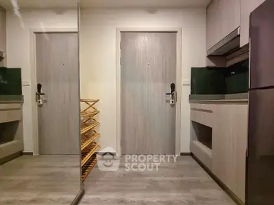 Modern kitchen with sleek cabinetry and stainless steel appliances in a compact layout.