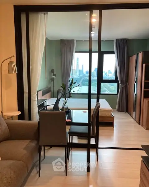 Modern studio apartment with city view and stylish interior design.