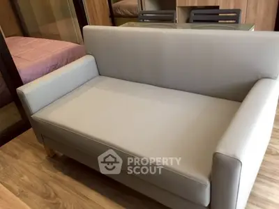 Modern living room with sleek gray sofa and wooden flooring