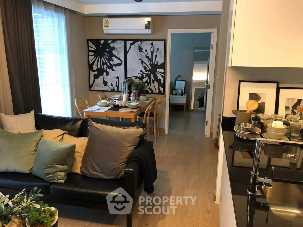 Stylish modern living room with dining area and kitchen in open layout apartment.