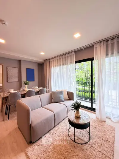 Modern living room with cozy sofa and garden view, perfect for relaxation and entertaining.