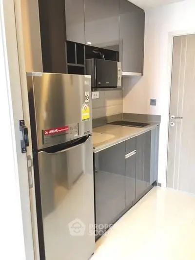 Modern compact kitchen with sleek cabinets and stainless steel appliances