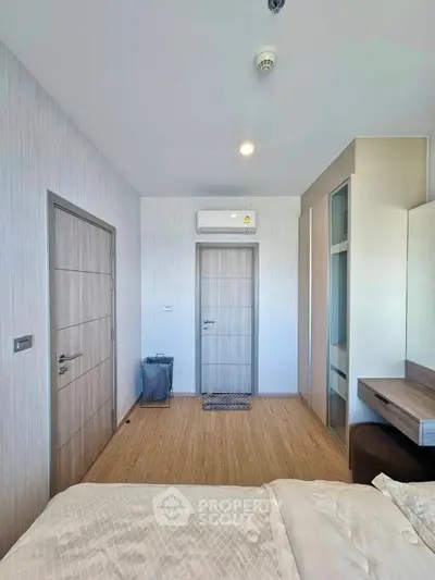 Modern bedroom with sleek design and air conditioning in a stylish apartment.