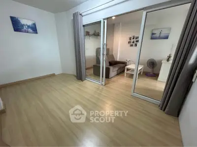 Spacious living room with sliding glass doors and wooden flooring
