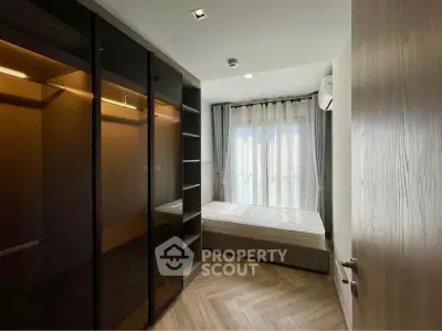 Modern bedroom with large wardrobe and natural light through sheer curtains.