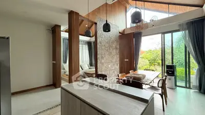 Modern open-plan living and dining area with large windows and garden view