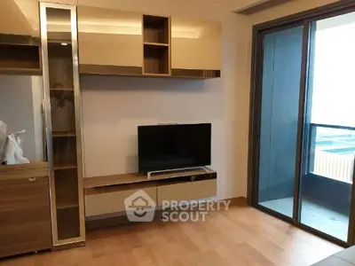 Modern living room with sleek TV unit and balcony access