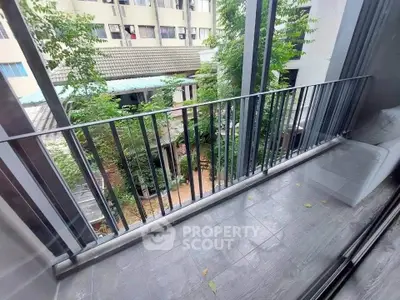 Charming balcony with serene garden view in modern apartment complex