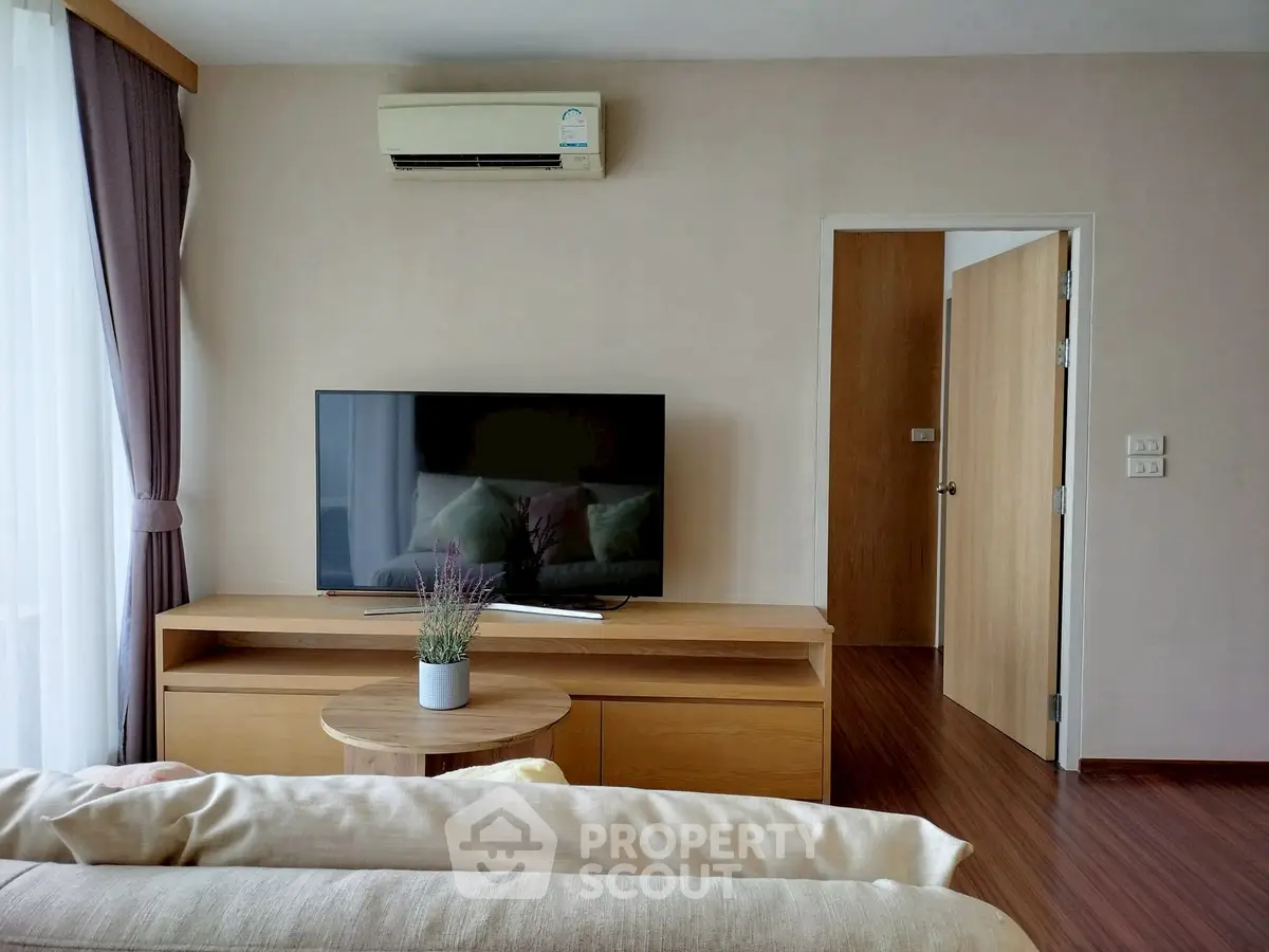 Modern living room with sleek TV setup and cozy decor