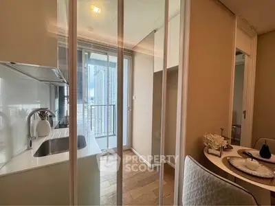 Modern kitchen with sleek design and balcony view, featuring elegant dining setup.