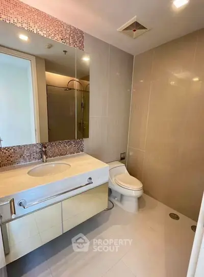 Modern bathroom with sleek fixtures and elegant tile design.