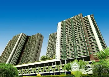 Stunning high-rise residential buildings with lush greenery and clear blue sky