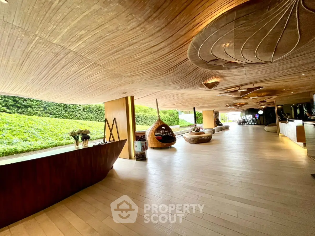 Luxurious modern lobby with unique wooden ceiling and stylish seating area
