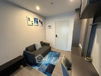 Modern living room with stylish decor and cozy seating in a contemporary apartment.
