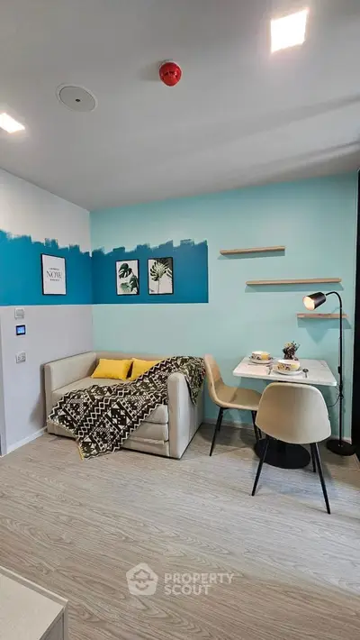 Modern living room with stylish decor, cozy sofa, and dining area in a chic apartment.