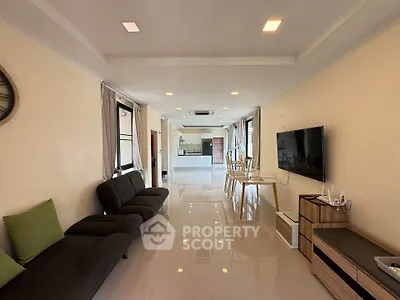 Spacious modern living room with sleek furniture and open layout, perfect for entertaining.